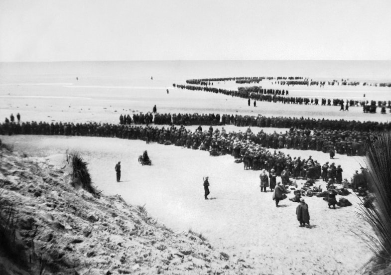 British troops line up on the beach at Dunkirk to await evacuation