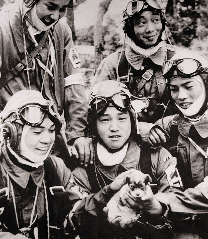 Corporal Yukio Araki (centre) holds a puppy in a group photo taken one day before his death, 26 May 1945.